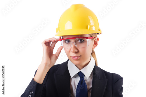 Photo: Young businesswoman with hard hat on white Young businesswoman with hard hat on white