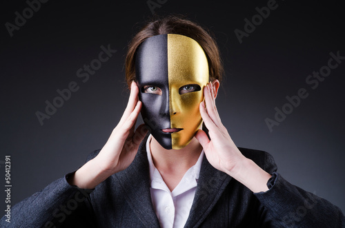 Photo: Woman with mask in hypocrisy concept Woman with mask in hypocrisy concept