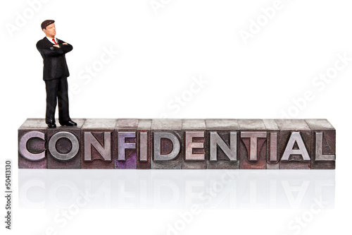 Photo: Confidential word in letterpress with miniature Confidential word in letterpress with miniature