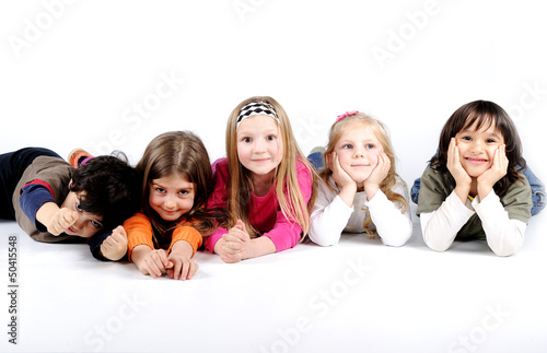 Photo: Children group family laying isolated Children group family laying isolated