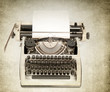 Antique typewriter on grunge background