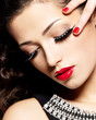 woman with creative makeup using false eyelashes