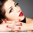 Beauty fashion woman with red nails and makeup