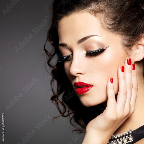 Photo: woman with creative makeup using false eyelashes woman with creative makeup using false eyelashes