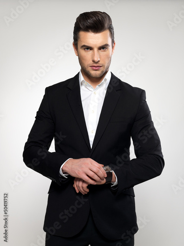 Photo: Fashion young businessman in black suit Fashion young businessman in black suit