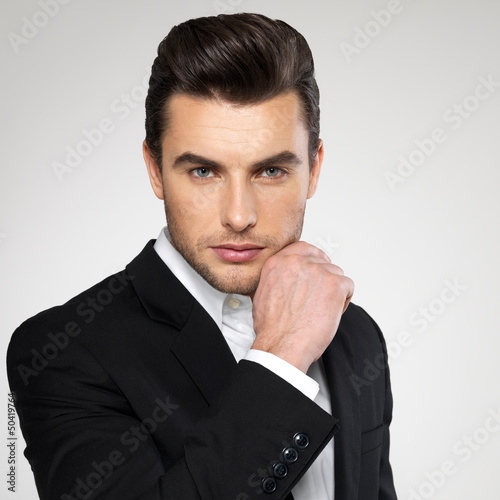 Photo: Fashion young businessman in black suit Fashion young businessman in black suit