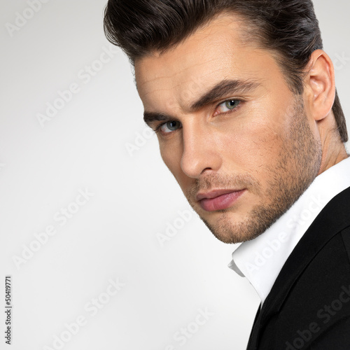 Fashion young businessman in black suit