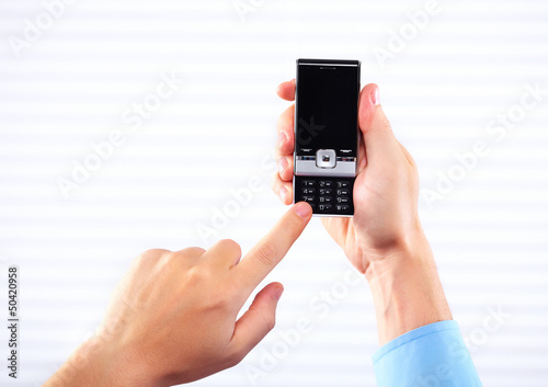 Photo: Hands of woman with a smartphone. Hands of woman with a smartphone.