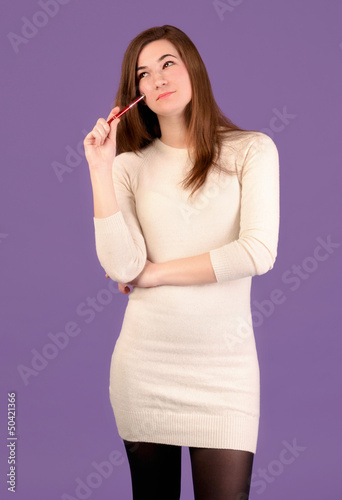 Photo: Portrait of a beautiful young woman thinking Portrait of a beautiful young woman thinking