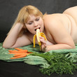 Overweight woman with fruits and vegetables. Diet concept.