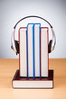 Concept of audio books with earphones on white