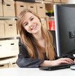 happy businesswoman with a computer at the office