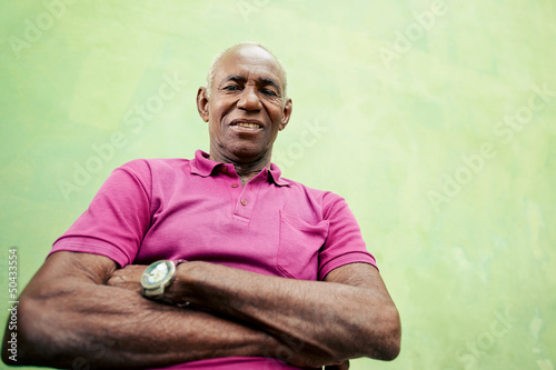 Photo: Portrait of elderly black man looking and smiling at camera Portrait of elderly black man looking and smiling at camera