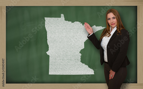 Photo: Teacher showing map of minnesota on blackboard Teacher showing map of minnesota on blackboard