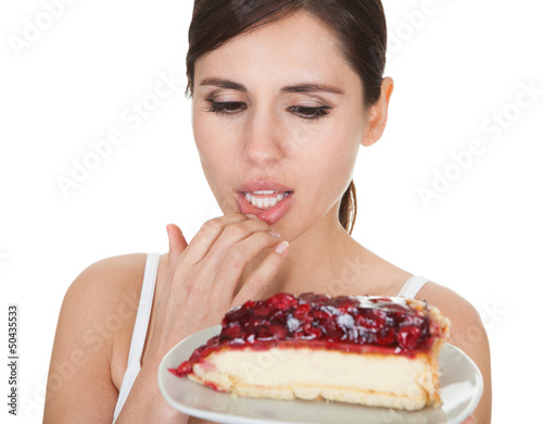 Photo: Young Woman Tasting Cake Young Woman Tasting Cake