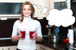 Photo: Beautiful happy smiling woman in kitchen interior holding glasse Beautiful happy smiling woman in kitchen interior holding glasse
