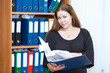 Photo: Attractive businesswoman with documents folder in hands Attractive businesswoman with documents folder in hands