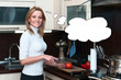 Photo: Beautiful happy smiling woman in kitchen interior cuts a tomato Beautiful happy smiling woman in kitchen interior cuts a tomato