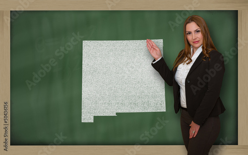 Photo: Teacher showing map of new mexico on blackboard Teacher showing map of new mexico on blackboard