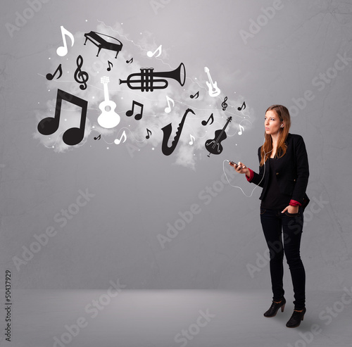Photo: Beautiful young woman singing and listening to music with musica Beautiful young woman singing and listening to music with musica