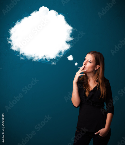 Photo: Young woman smoking unhealthy cigarette with dense smoke Young woman smoking unhealthy cigarette with dense smoke