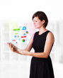 Young woman looking at modern tablet with colourful technology i