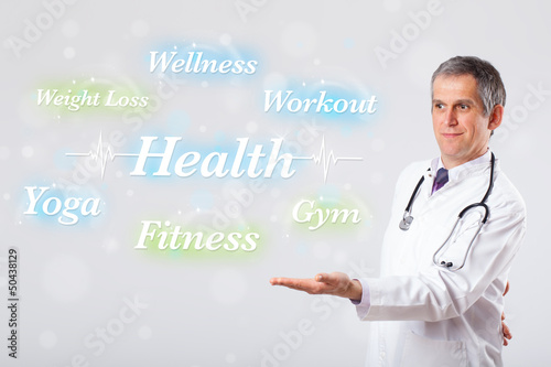 Photo: Clinical doctor pointing to health and fitness collection of wor Clinical doctor pointing to health and fitness collection of wor