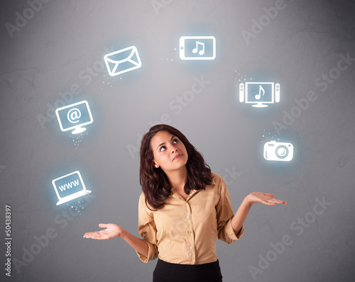 Photo: pretty girl juggling with elecrtonic devices icons pretty girl juggling with elecrtonic devices icons