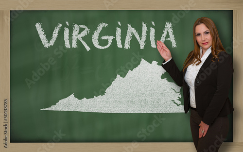 Photo: Teacher showing map of virginia on blackboard Teacher showing map of virginia on blackboard