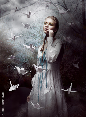 Photo: Night. Woman in Mysterious Forest launching Cranes. Origami Night. Woman in Mysterious Forest launching Cranes. Origami