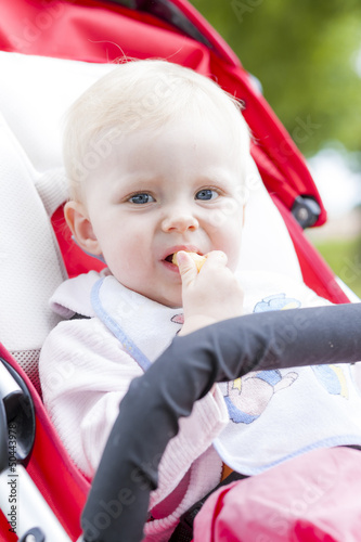 Photo: portrait of toddler sitting in a pram portrait of toddler sitting in a pram