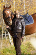 equestrian with her horse in autumnal nature