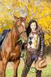 equestrian with her horse in autumnal nature