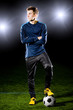 football player on grass field. Sport portrait.