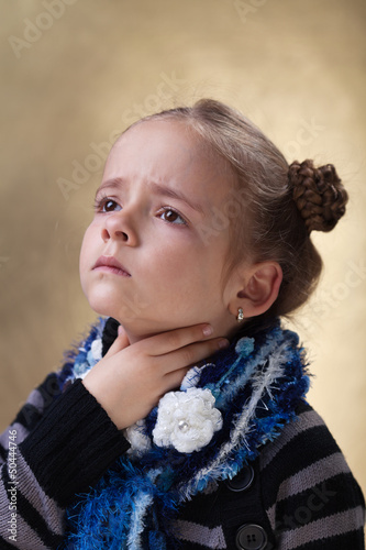 Photo: Little girl with sore throat in flu season Little girl with sore throat in flu season