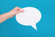 Hand holding an empty speech bubble