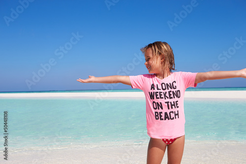 Photo: Young Girl Enjoying Beach Holiday Young Girl Enjoying Beach Holiday