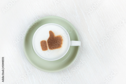 Photo: Thumbs up sign on cappuccino Thumbs up sign on cappuccino