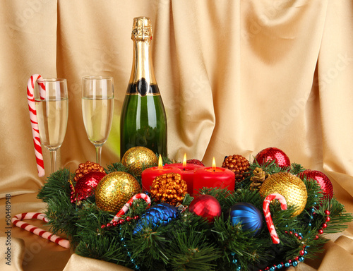Photo: Beautiful Christmas wreath in composition with champagne Beautiful Christmas wreath in composition with champagne