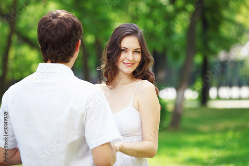 Photo: Young love Couple smiling under blue sky Young love Couple smiling under blue sky