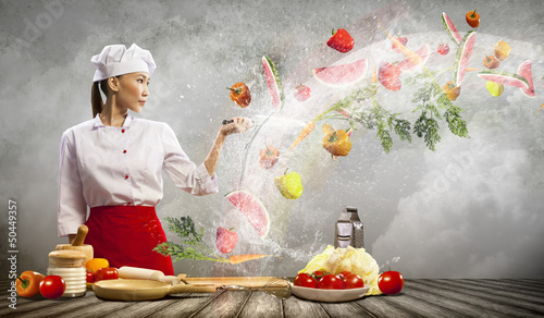 Photo: Asian female cook with knife Asian female cook with knife