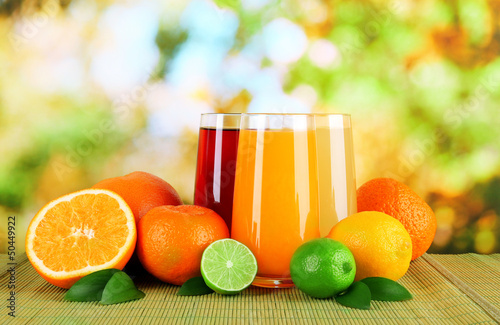 Photo: Glasses of juise with leafs and fruits Glasses of juise with leafs and fruits