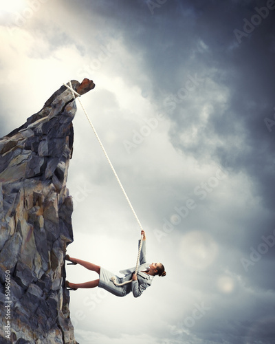 Photo: businesswoman climbing mountain businesswoman climbing mountain