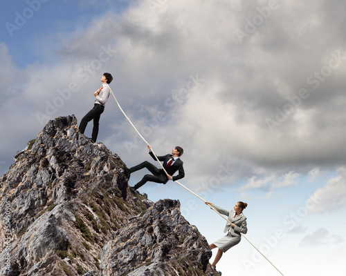 Photo: Three business people pulling rope Three business people pulling rope