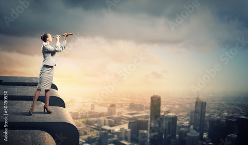 Photo: Business woman with telescope Business woman with telescope