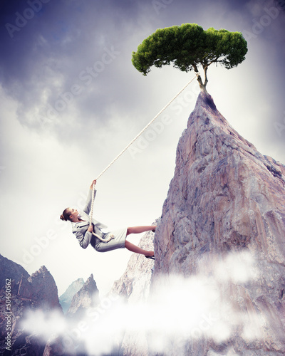 Photo: businesswoman climbing mountain businesswoman climbing mountain