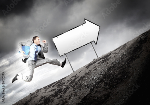 Photo: Businessman running on the road Businessman running on the road