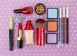 Decorative cosmetics on purple background