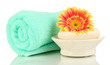 Rolled towel, soap bar and beautiful flower isolated on white