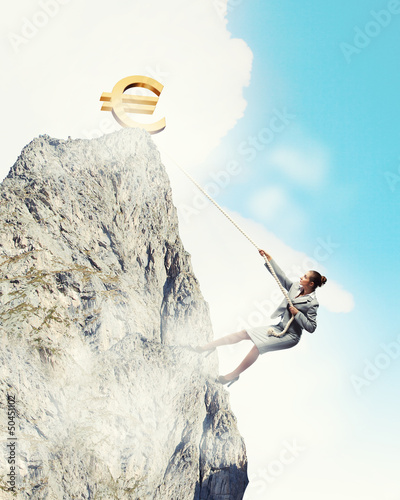 Photo: businesswoman climbing mountain businesswoman climbing mountain